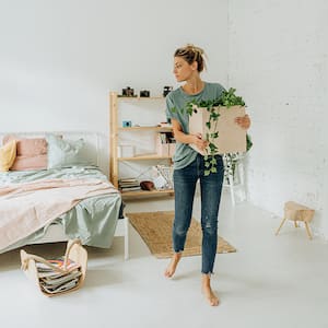 woman organizing and decorating bedroom    